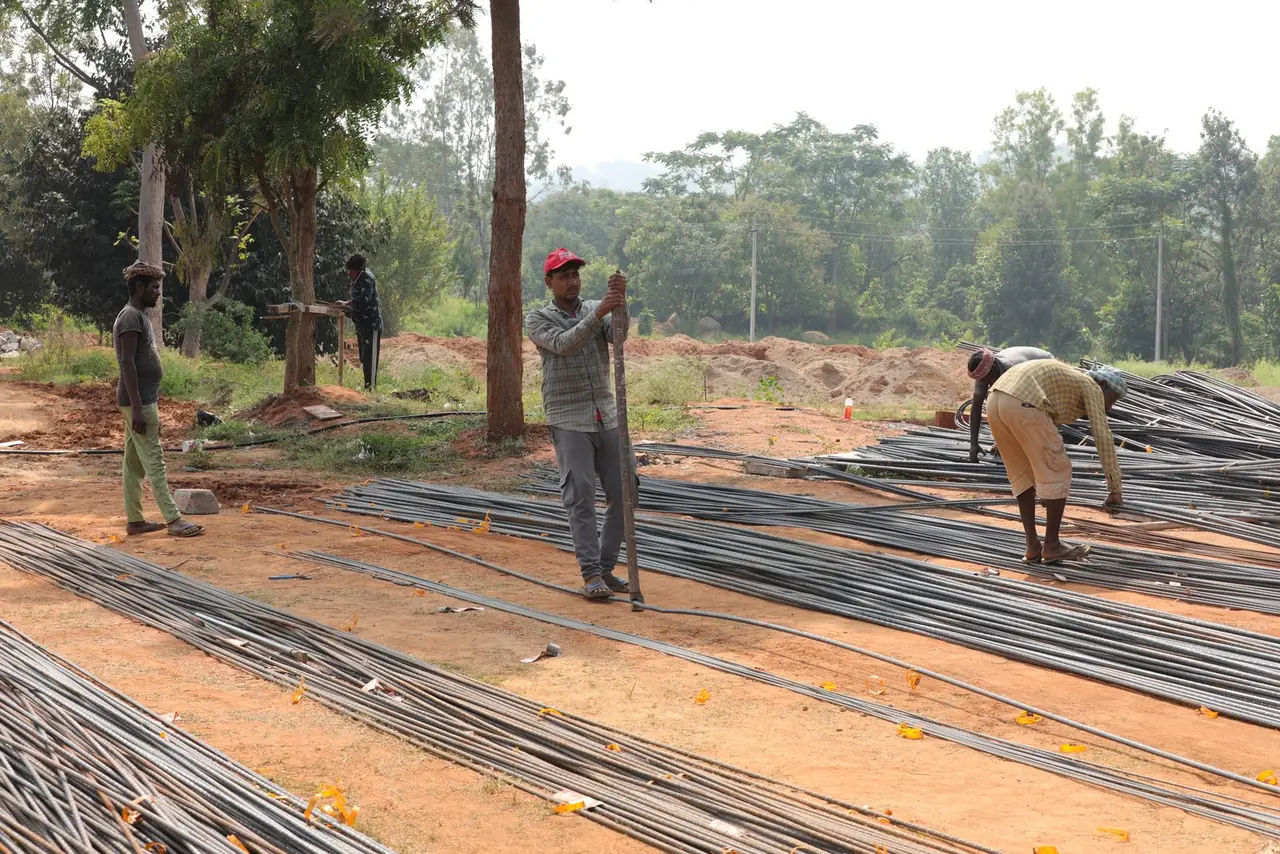 Workers tying reinforcement bars for the hostel at Bachenahatti