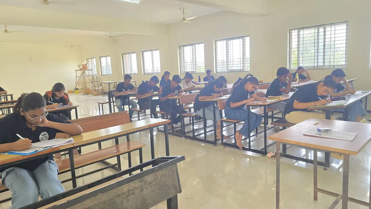 Students writing a full-length NEET practice test in a classroom